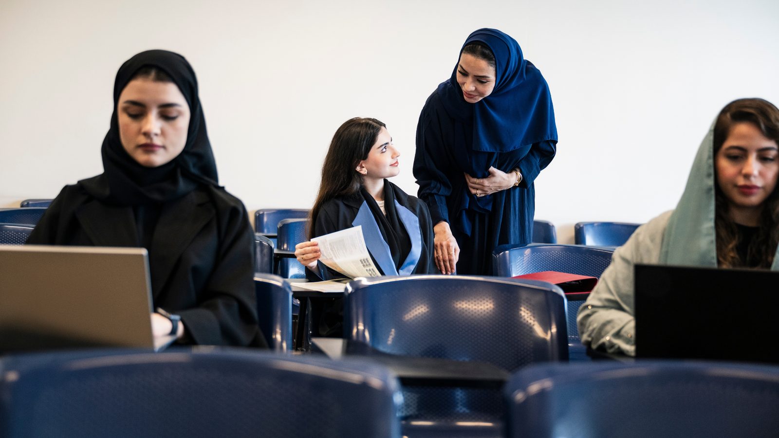 Students working on laptops in a lecture hall