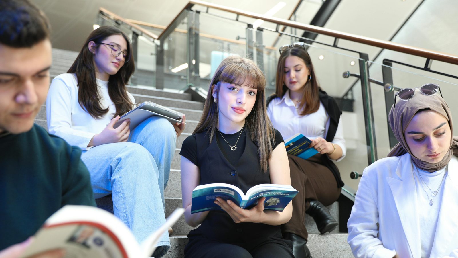 Students reading together on a campus staircase
